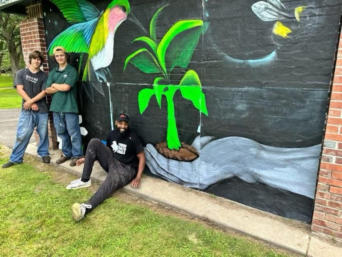 Community members in front of a finished Chess Angels mural